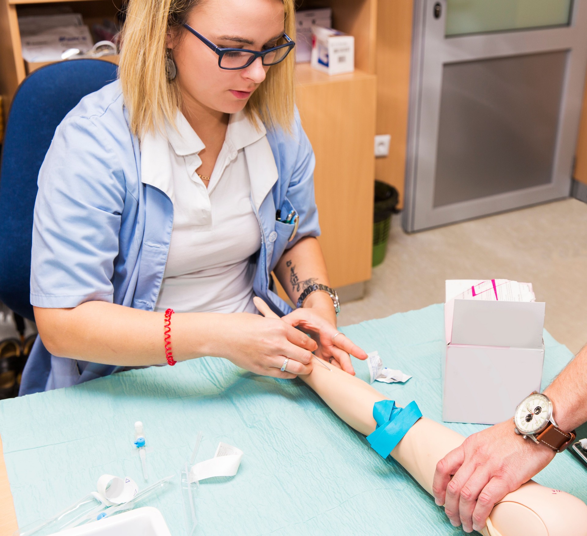 Nurse training intravenous therapy on dummy